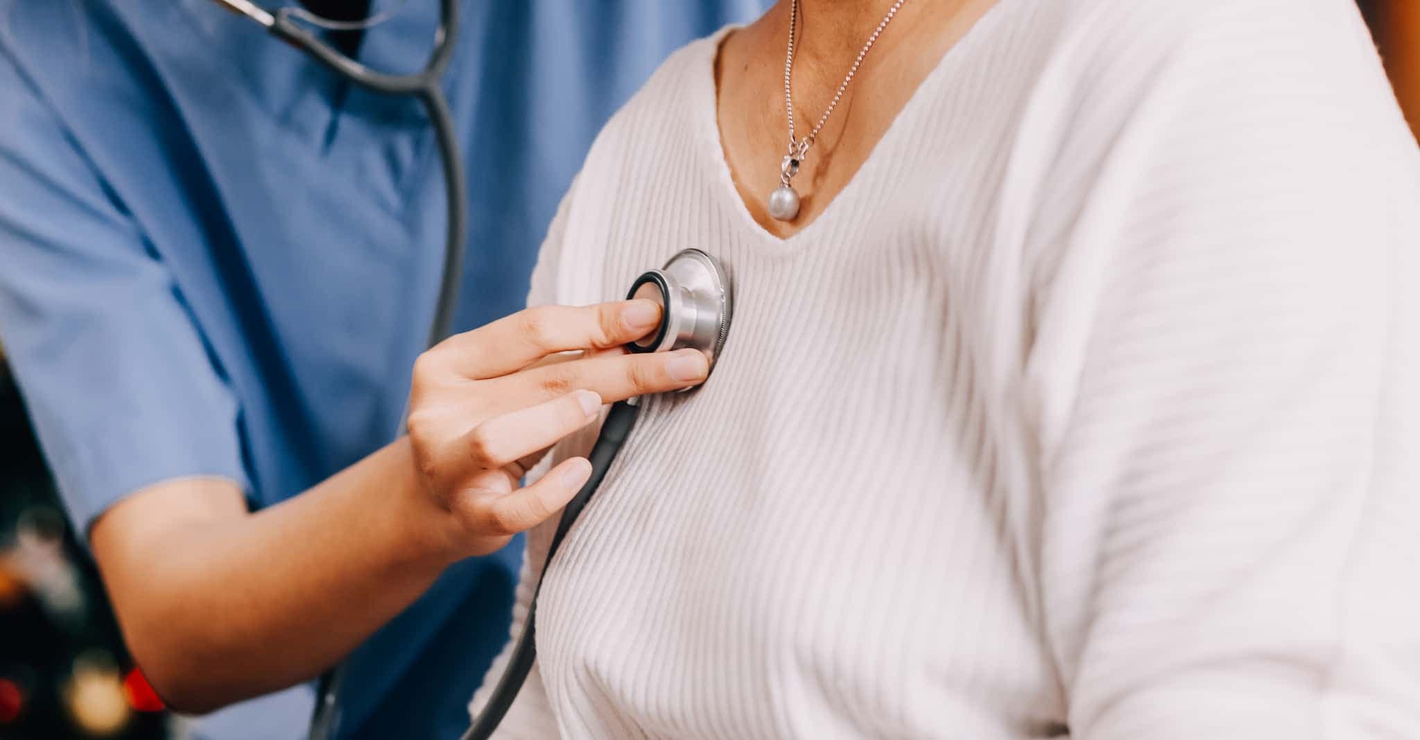 A doctor is examining a patient's lungs with a stethoscope.