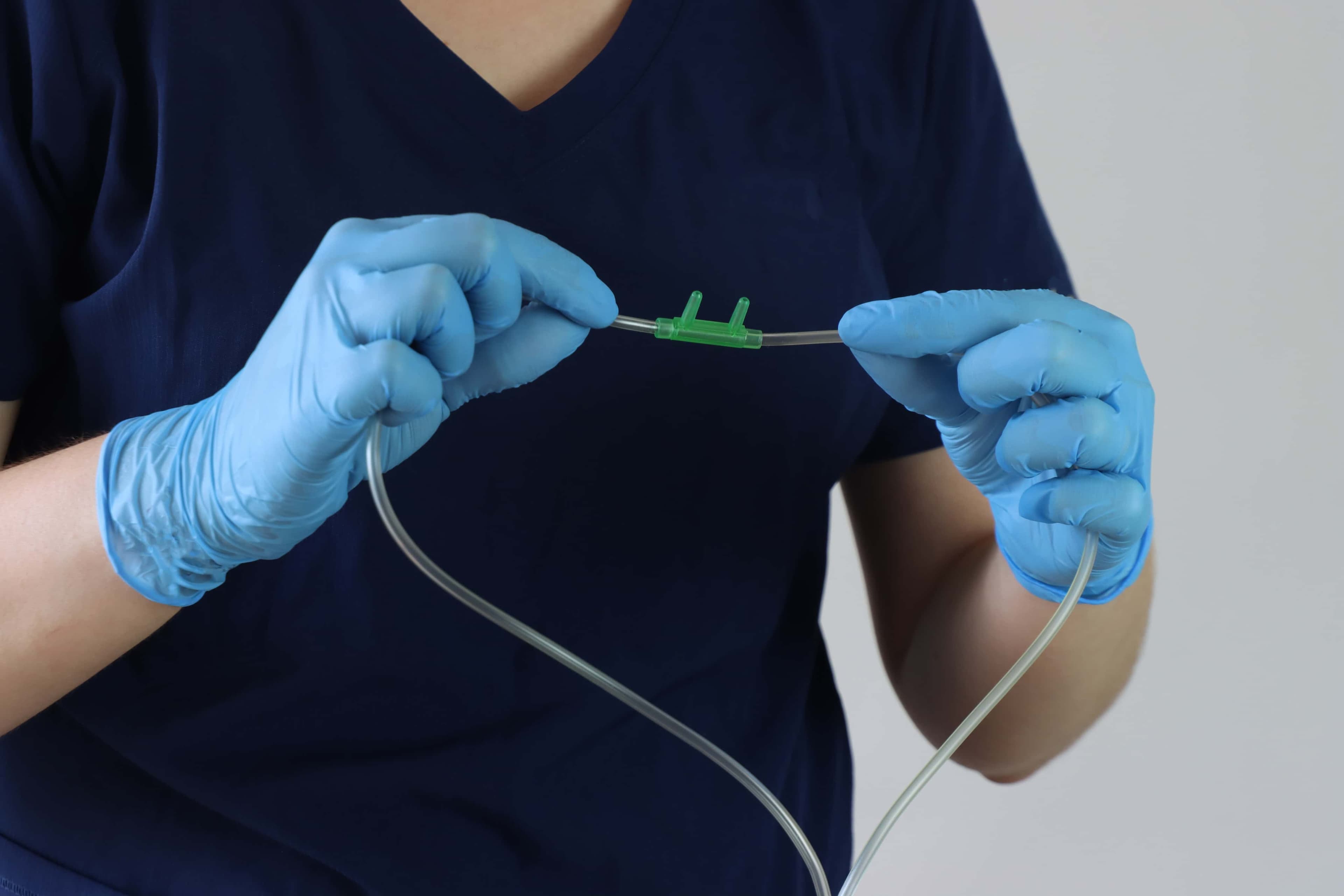 A nurse is preparing a nasal cannula.