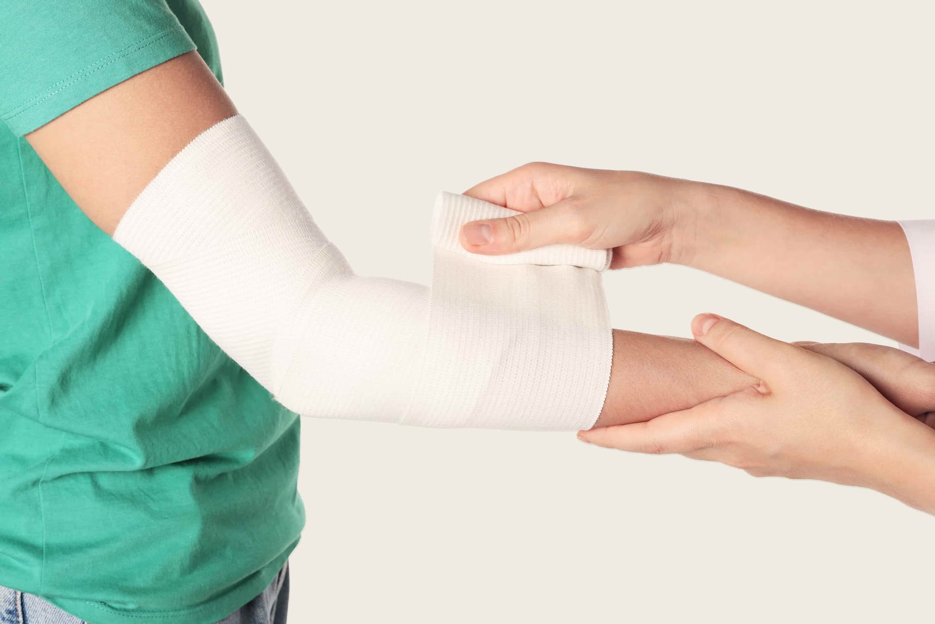 A doctor applying a bandage to a patient's arm.