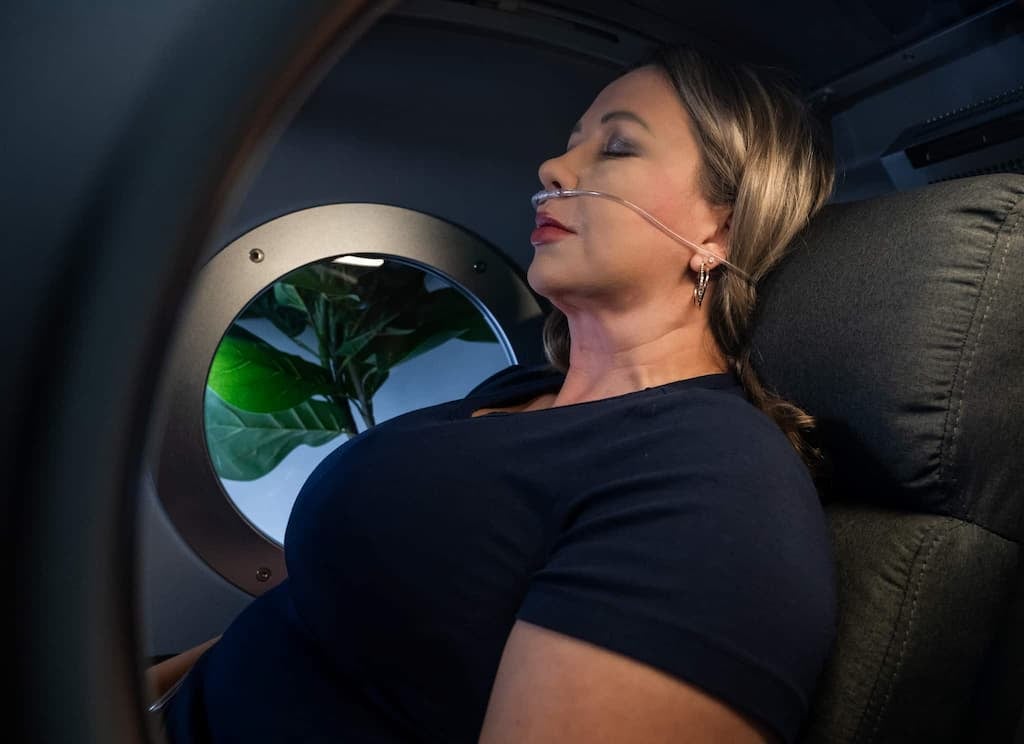 A woman is seen having a treatment inside the OxyRenew hyperbaric oxygen chamber
